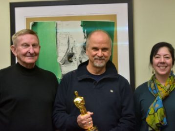 Professor Emeritus Frank Beaver, John Nelson, and Department Chair Yeidy Rivero pose for a photo in the SAC office